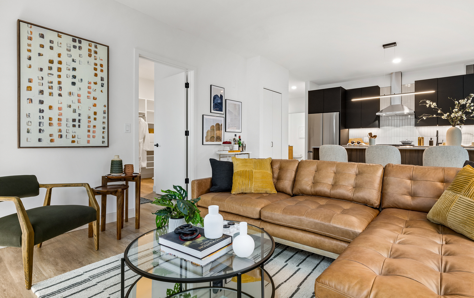 218 East Grand Avenue, Unit 1205 Chicago, IL 60611 - Photo 3 of 20 a living room with furniture a flat screen tv and kitchen view