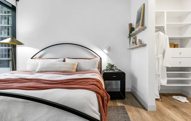 a bedroom with a bed and a mirror