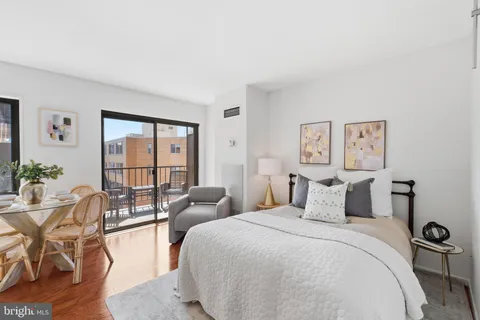 a bedroom with a bed and a large window