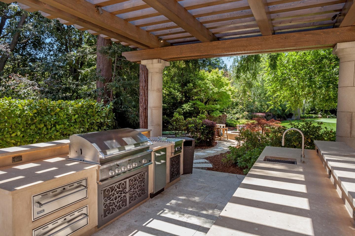 1 Faxon Road Atherton, CA 94027 - Photo 3 of 19 a view of a patio with table and chairs potted plants with wooden floor and fence