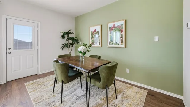 a view of a dining room with furniture and wooden floor