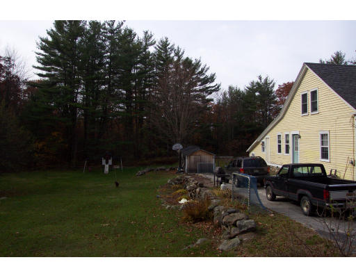 36 Healdville Road Hubbardston, MA 01452 - Photo 2 of 4 a backyard of a house with table and chairs