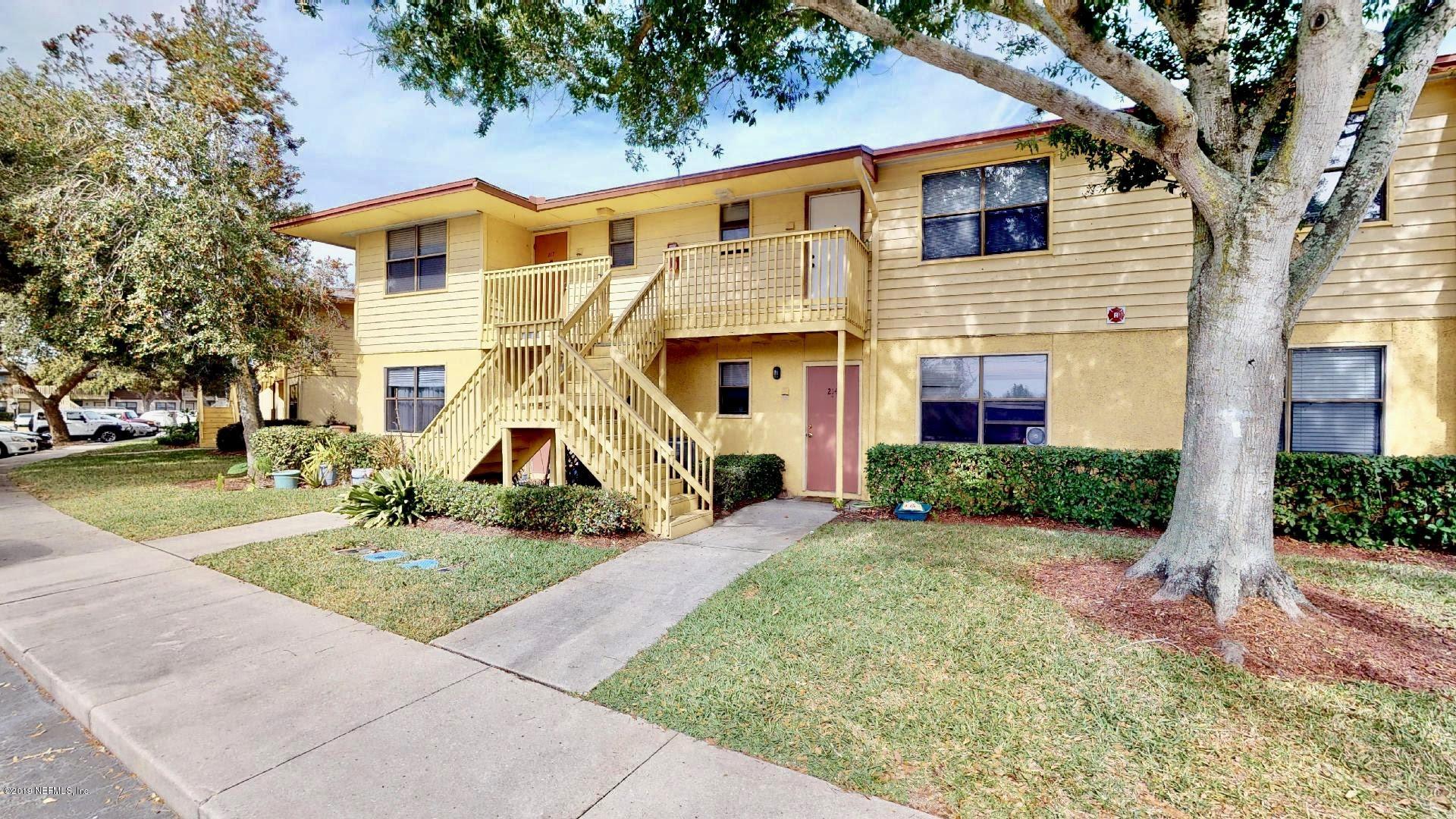 650 Pope Road, Unit 217 St. Augustine, FL 32080 - Photo 1 of 25 a view of a white house with a yard and potted plants