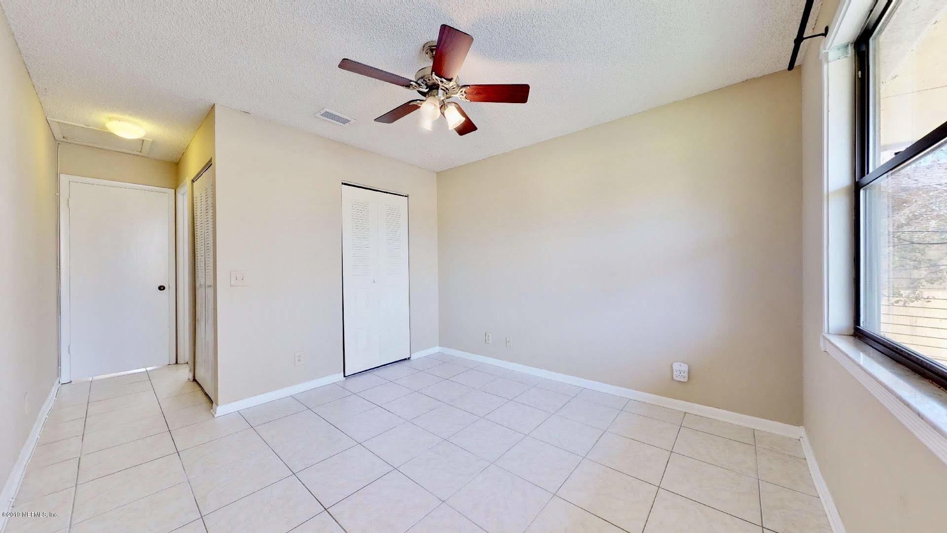 650 Pope Road, Unit 217 St. Augustine, FL 32080 - Photo 11 of 25 a view of a livingroom with a ceiling fan and window