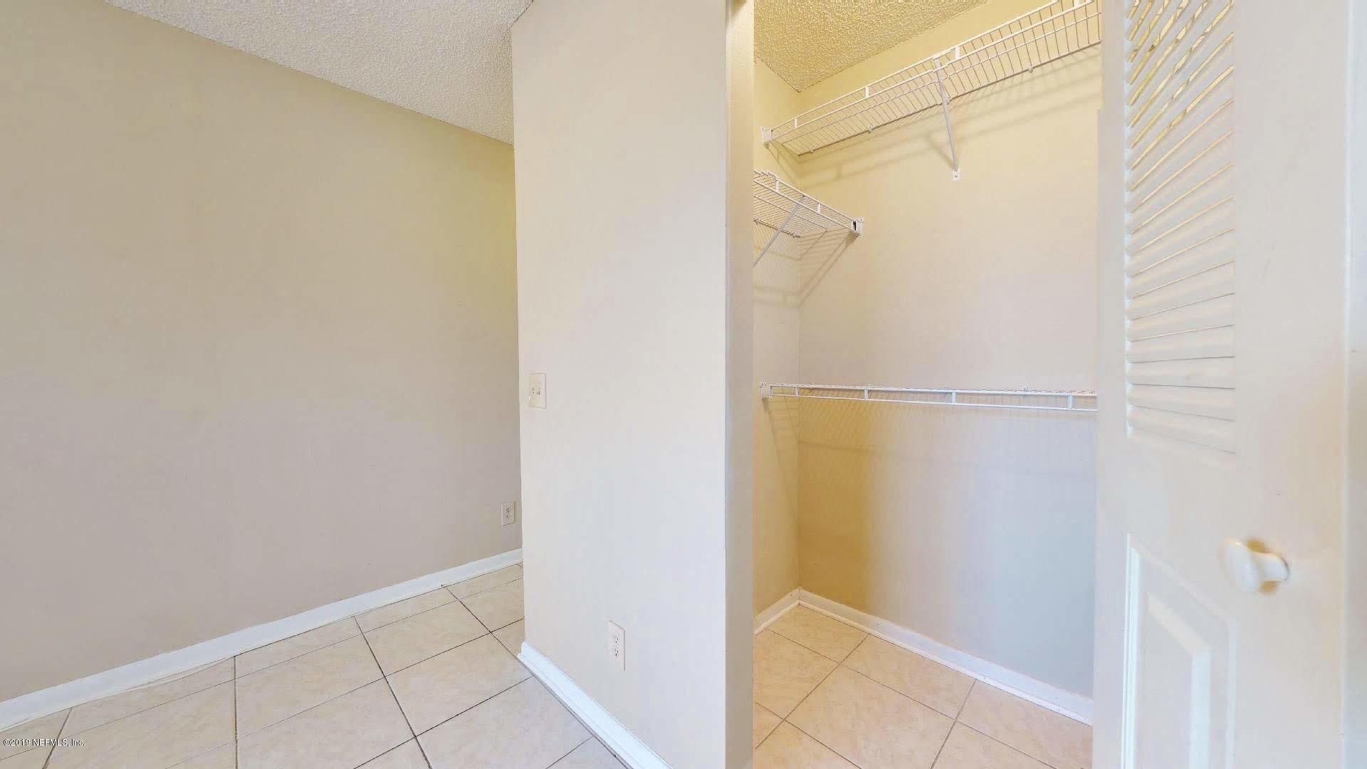 650 Pope Road, Unit 217 St. Augustine, FL 32080 - Photo 12 of 25 a bathroom with a glass shower door
