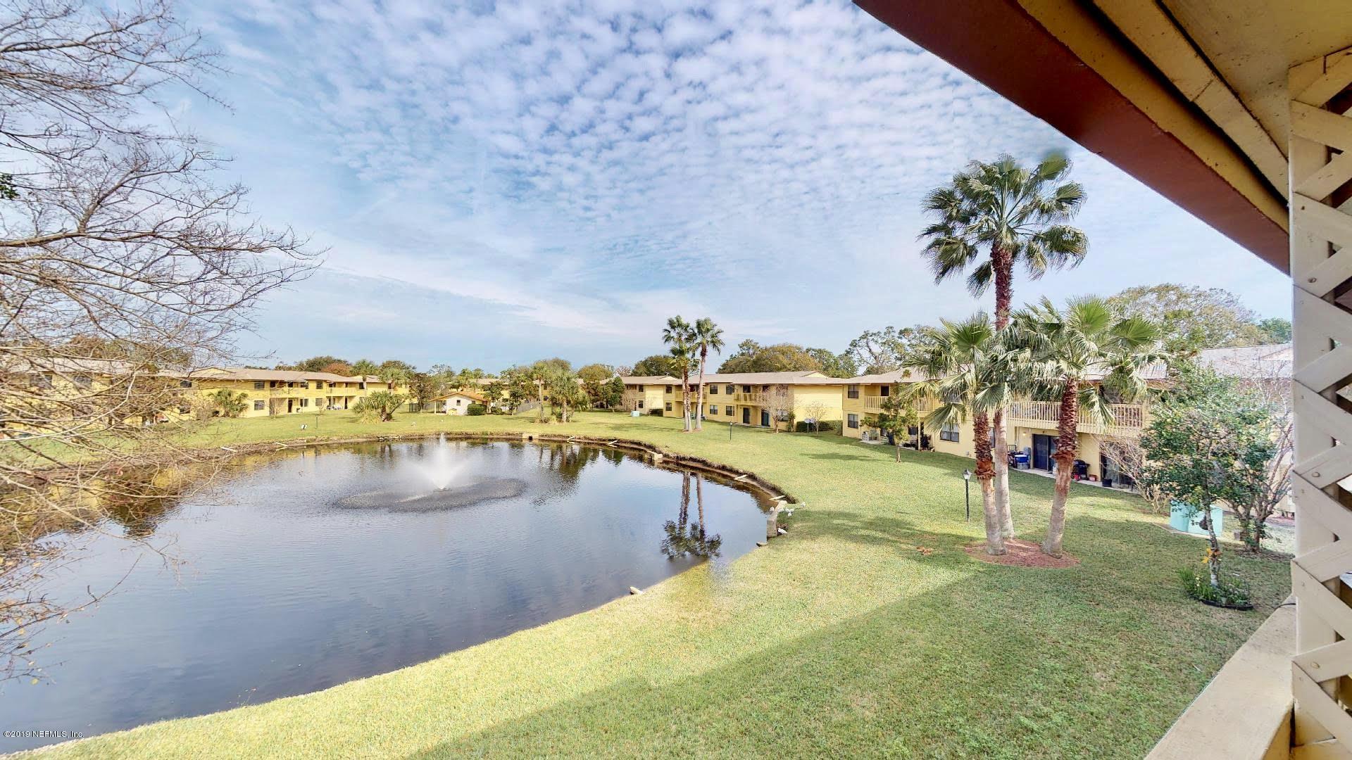 650 Pope Road, Unit 217 St. Augustine, FL 32080 - Photo 19 of 25 a view of a lake with houses in the back