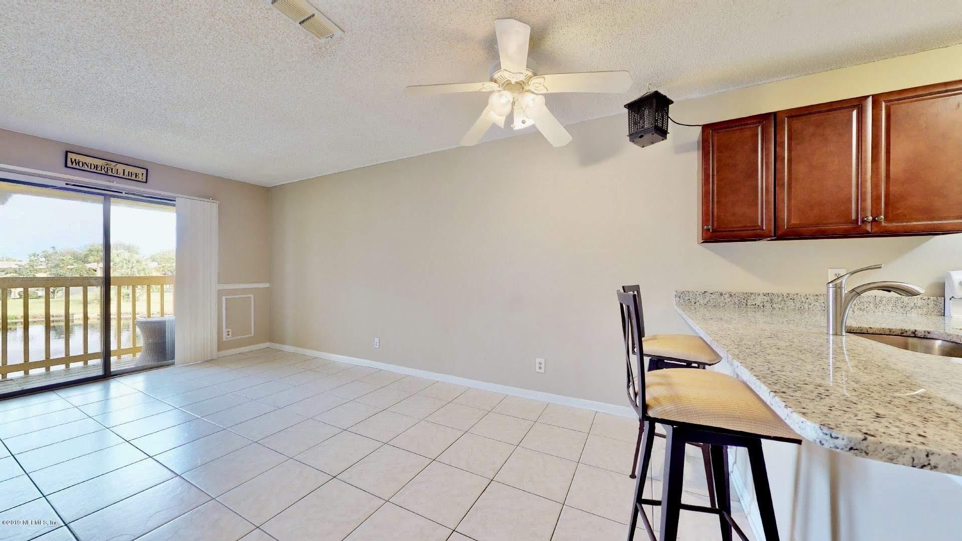650 Pope Road, Unit 217 St. Augustine, FL 32080 - Photo 2 of 25 a kitchen with granite countertop a stove a sink and a microwave