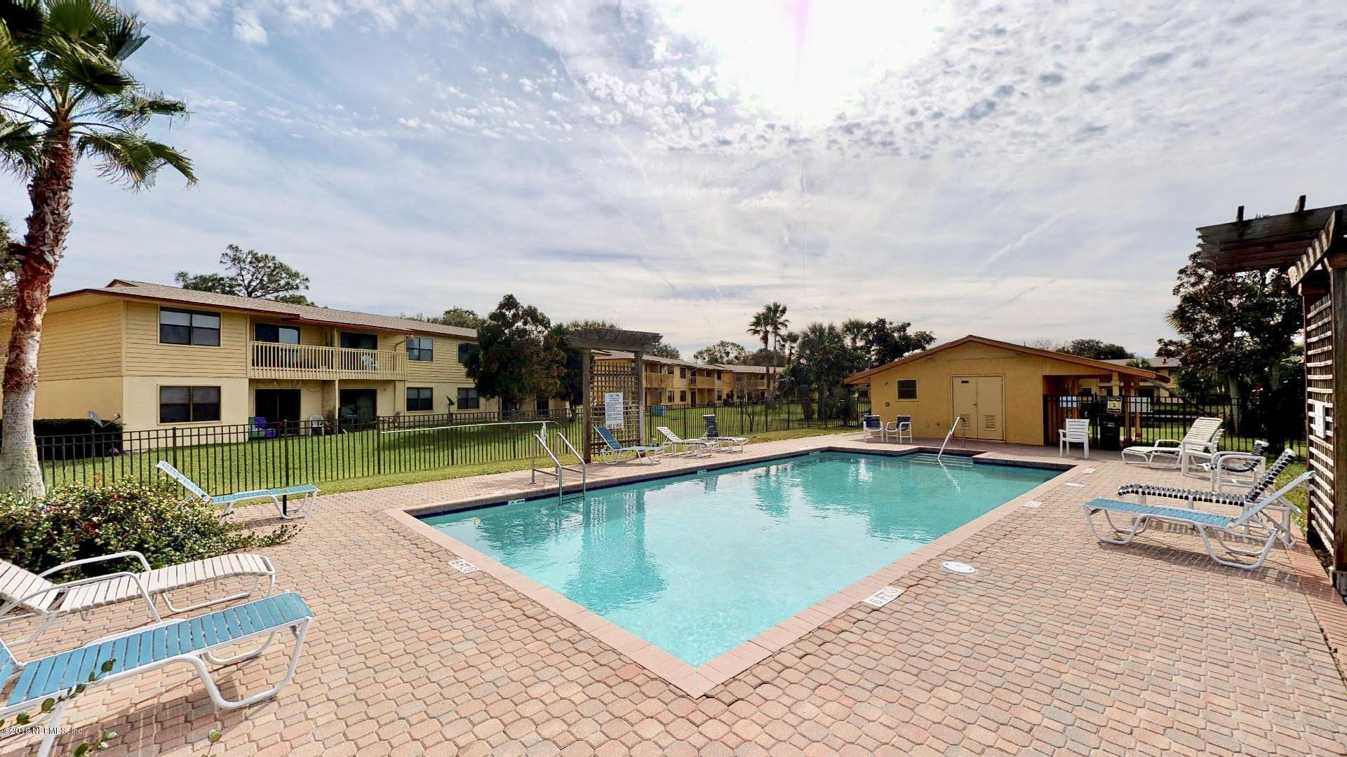 650 Pope Road, Unit 217 St. Augustine, FL 32080 - Photo 22 of 25 a view of a swimming pool with a lounge chairs