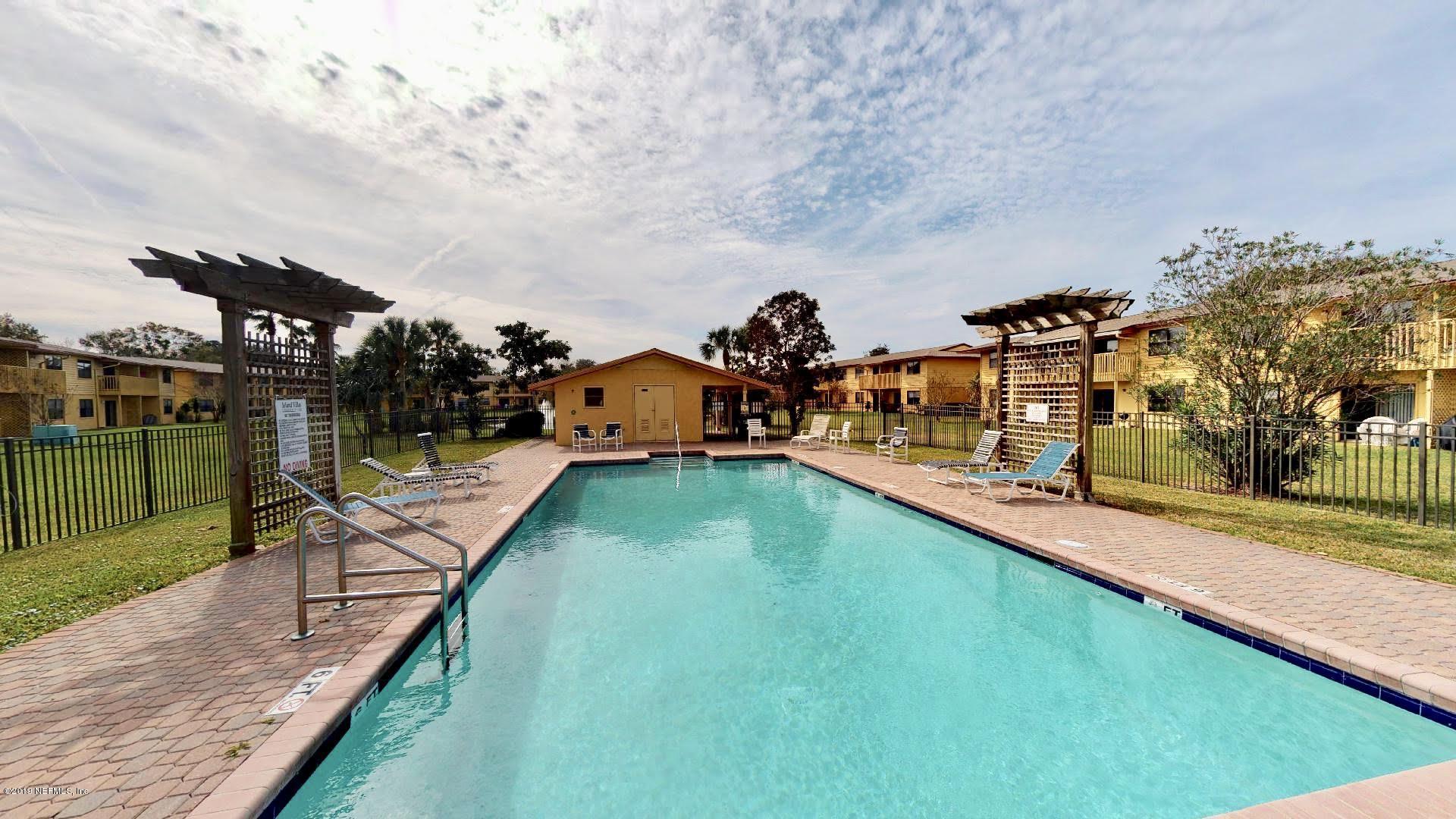 650 Pope Road, Unit 217 St. Augustine, FL 32080 - Photo 23 of 25 a view of a swimming pool with a patio and a yard