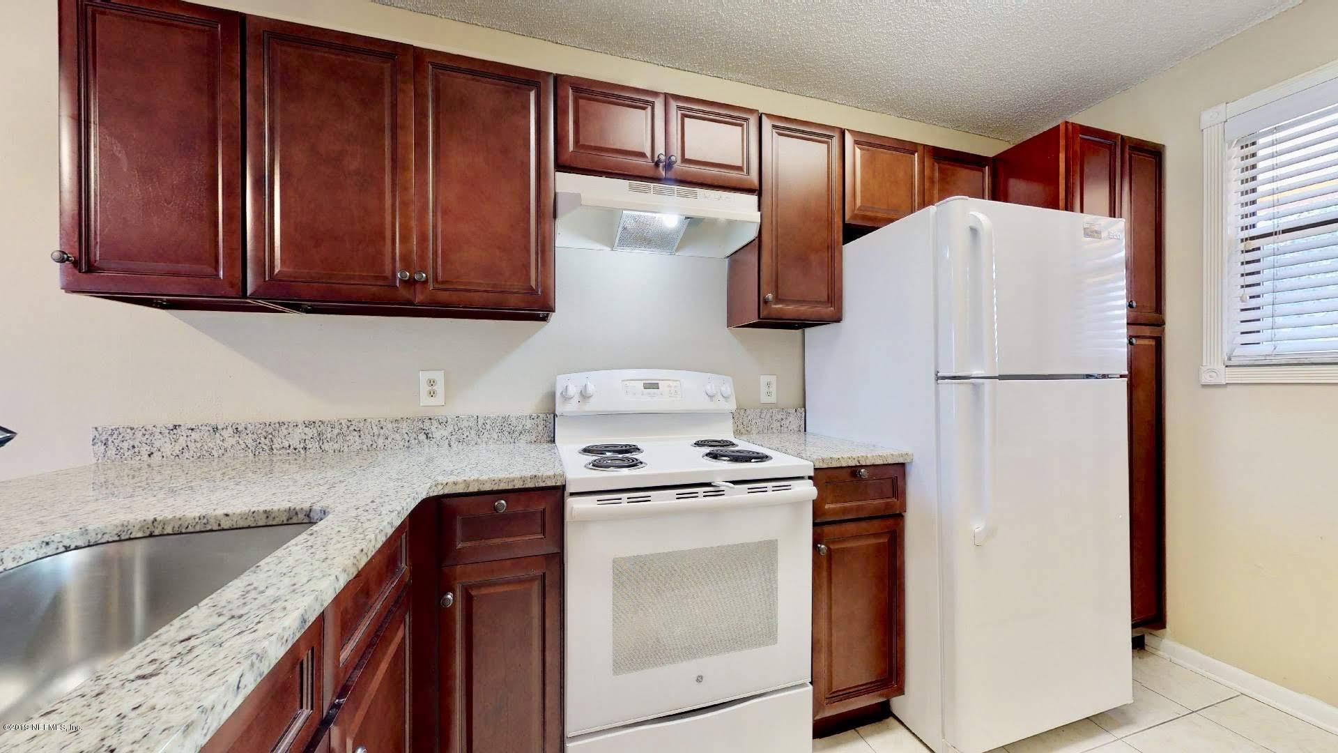 650 Pope Road, Unit 217 St. Augustine, FL 32080 - Photo 3 of 25 a kitchen with stainless steel appliances granite countertop a refrigerator sink and stove