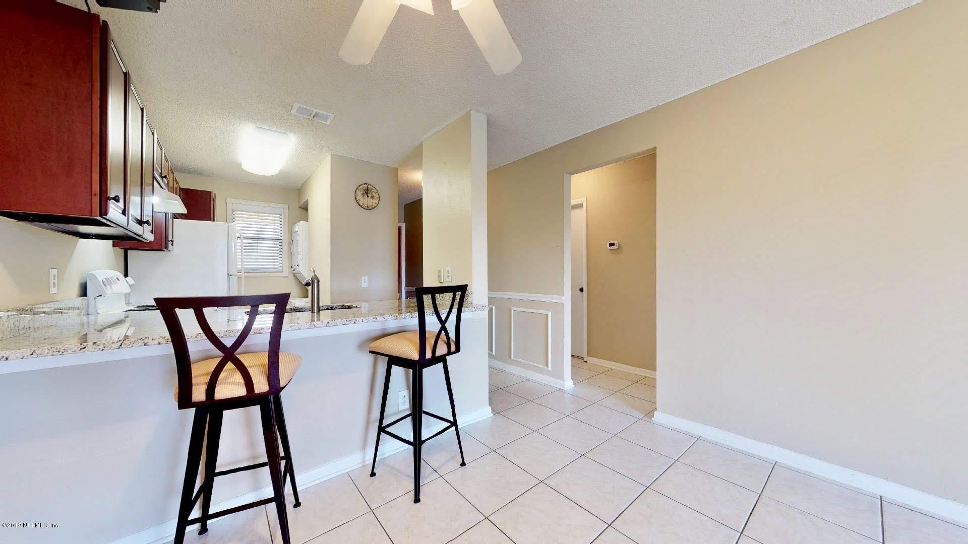 650 Pope Road, Unit 217 St. Augustine, FL 32080 - Photo 4 of 25 a very nice looking room with a glass top table and chairs