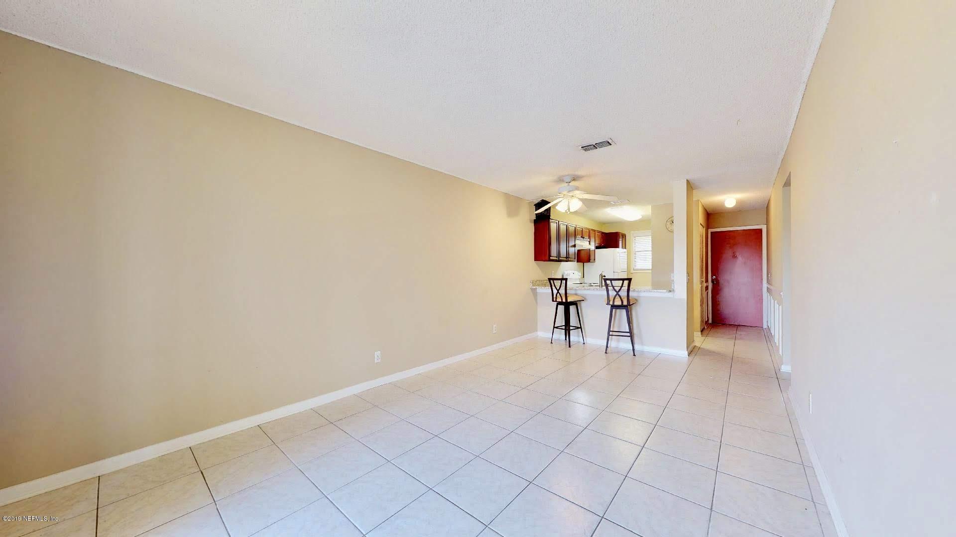 650 Pope Road, Unit 217 St. Augustine, FL 32080 - Photo 6 of 25 a view of a room with furniture and a kitchen