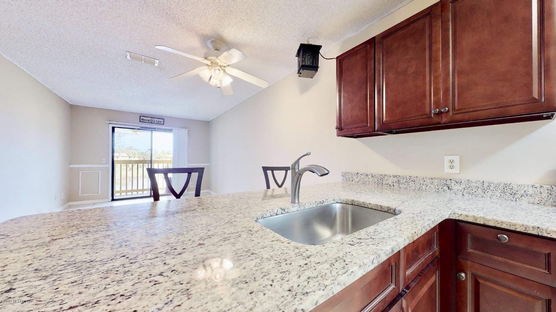 650 Pope Road, Unit 217 St. Augustine, FL 32080 - Photo 7 of 25 a kitchen with a sink cabinets and window