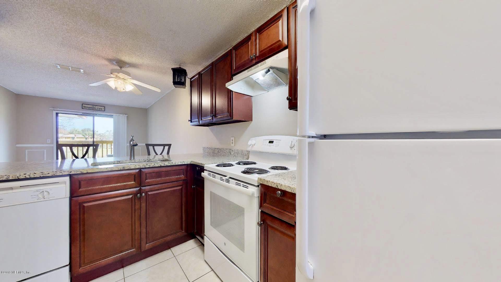 650 Pope Road, Unit 217 St. Augustine, FL 32080 - Photo 9 of 25 a kitchen with stainless steel appliances granite countertop a sink and a stove