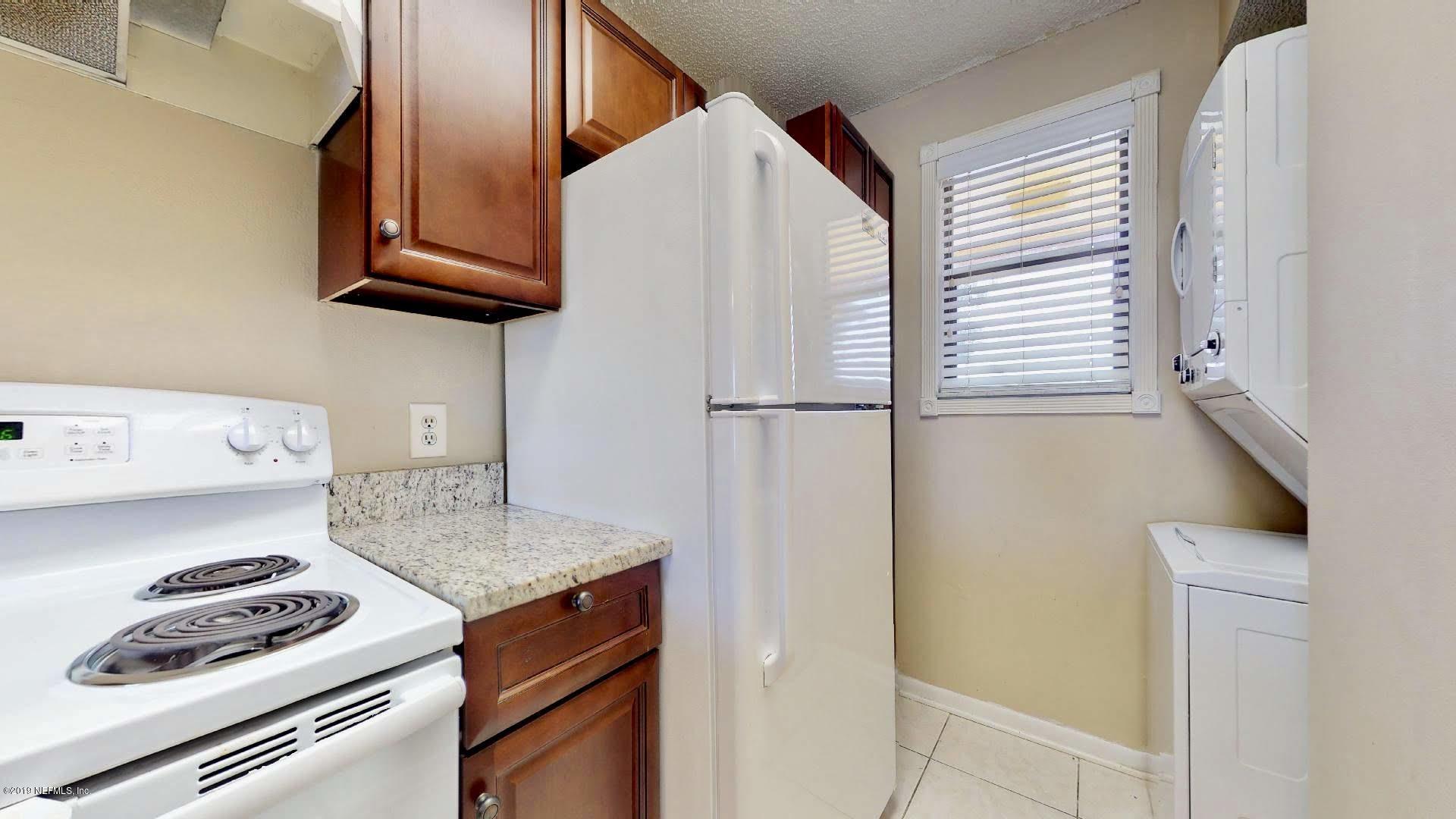 650 Pope Road, Unit 217 St. Augustine, FL 32080 - Photo 10 of 25 a kitchen with stainless steel appliances granite countertop a refrigerator and a stove