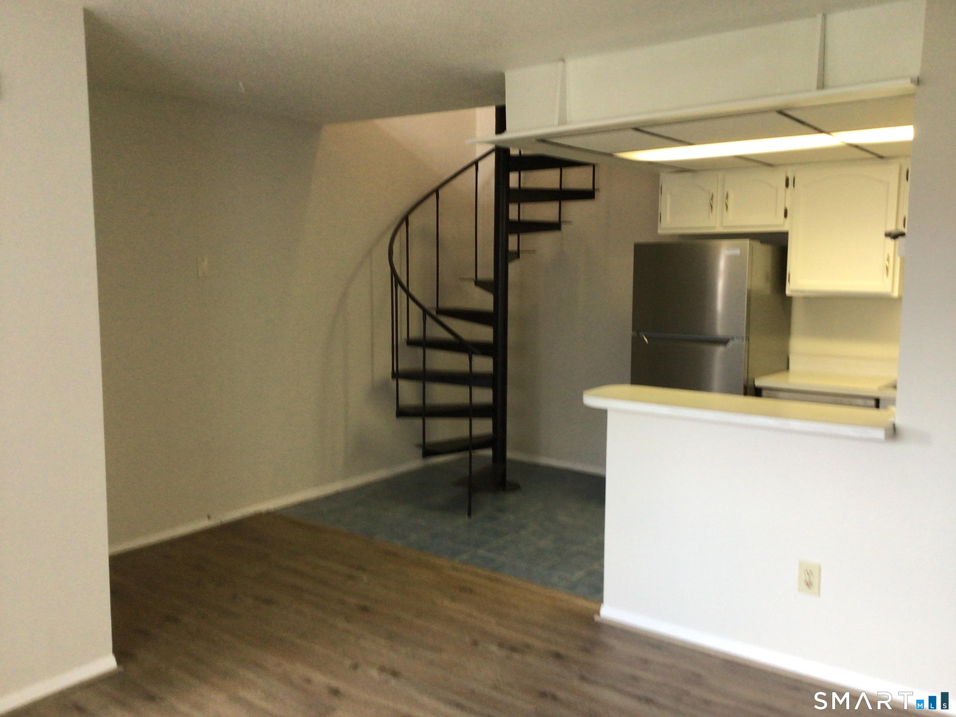 330 Short Beach Road, Unit G12 East Haven, CT 06512 - Photo 4 of 22 a view of a storage & utility room with wooden floor