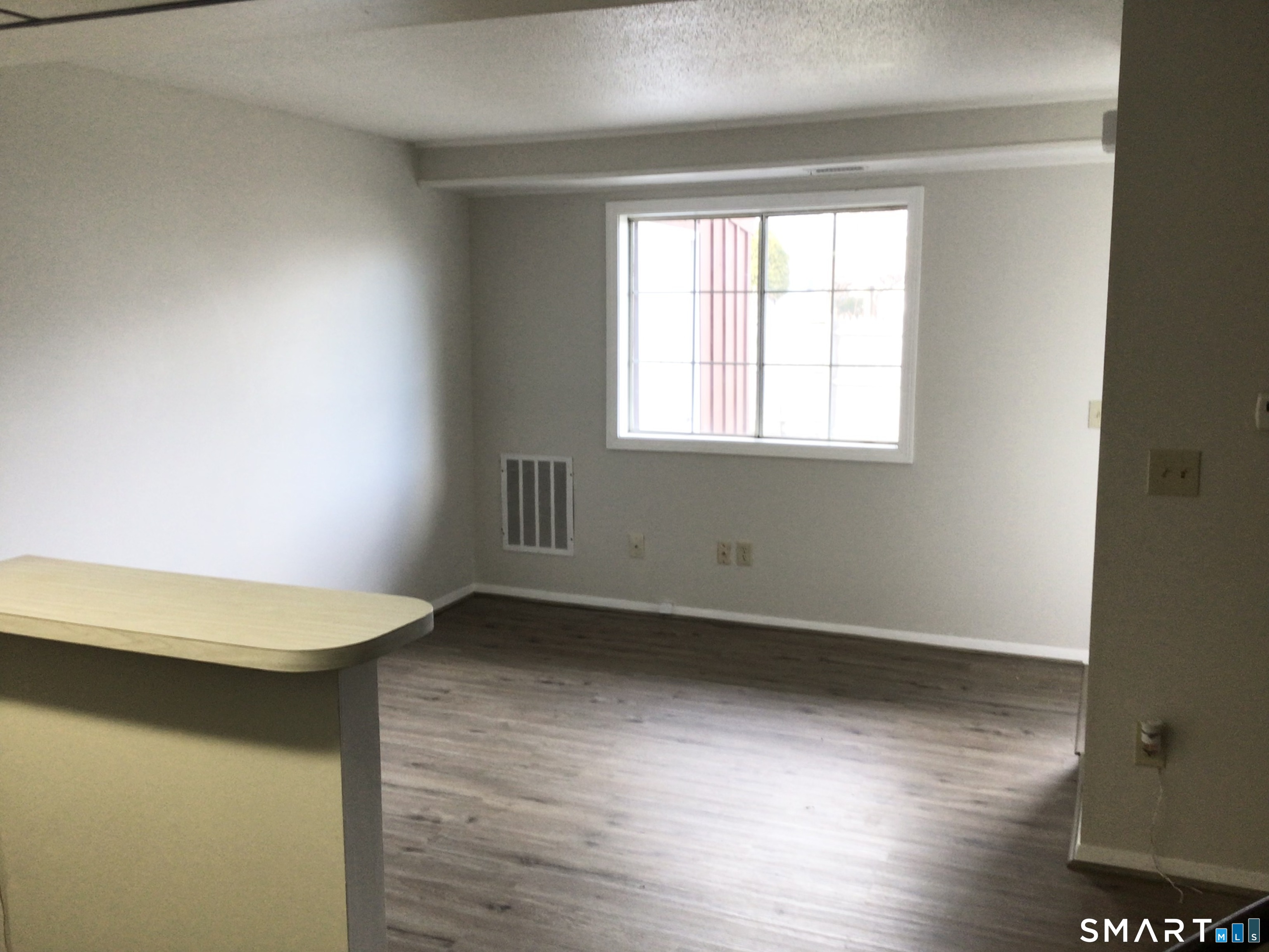 330 Short Beach Road, Unit G12 East Haven, CT 06512 - Photo 6 of 22 an empty room with wooden floor and window