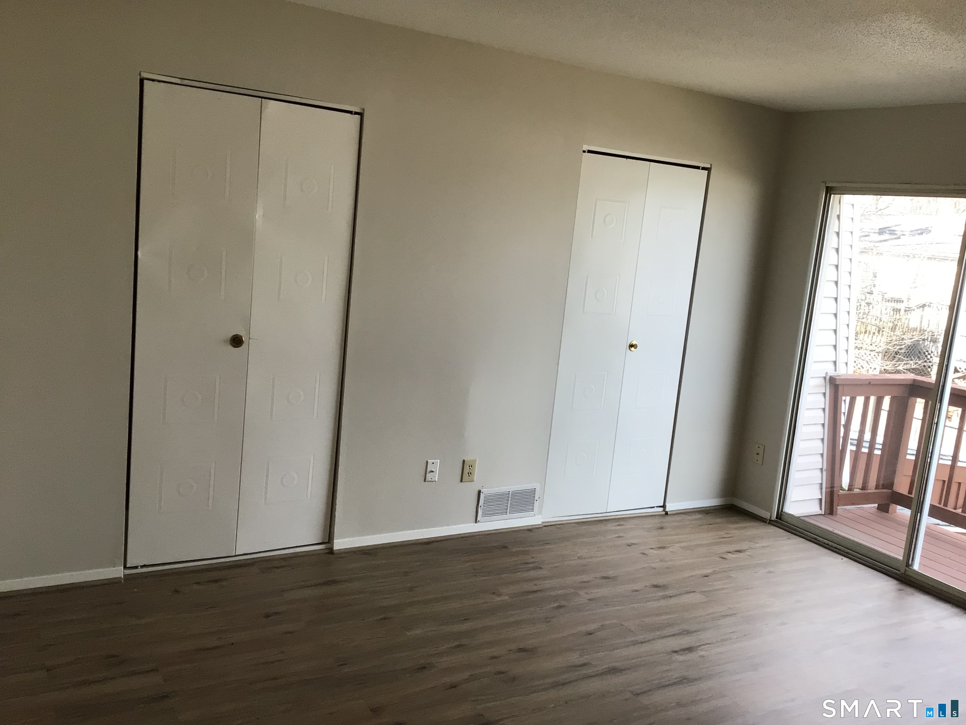 330 Short Beach Road, Unit G12 East Haven, CT 06512 - Photo 9 of 22 a view of an empty room with wooden floor and a window