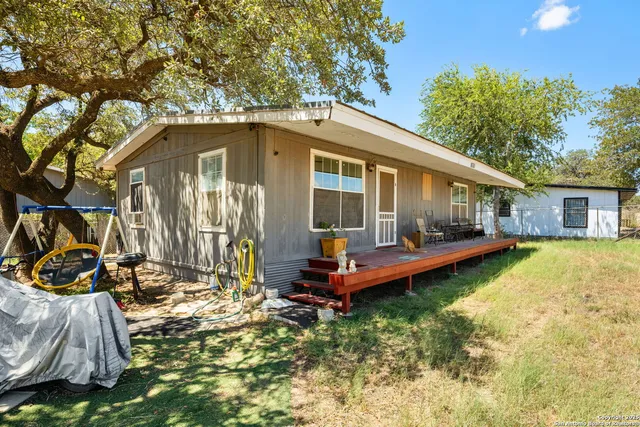 a front view of house with yard outdoor seating and barbeque oven