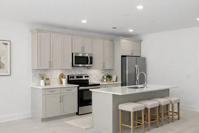 a kitchen with a sink cabinets and stainless steel appliances