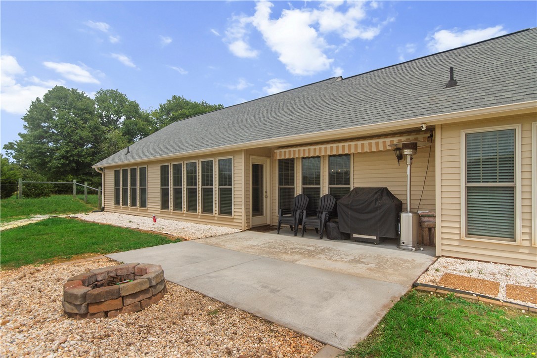 2900 Highway 187 Anderson, SC 29626 - Photo 6 of 41 An inviting backyard patio features a fire pit, ideal for evening relaxation and outdoor enjoyment.