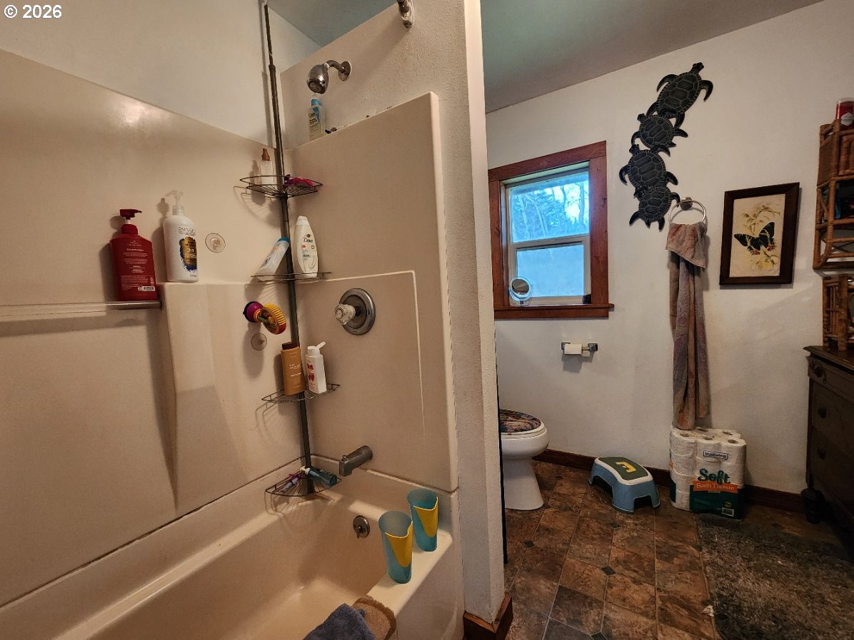 45366 Highway 101 Sixes, OR 97476 - Photo 12 of 34 a bathroom with a sink and toilet