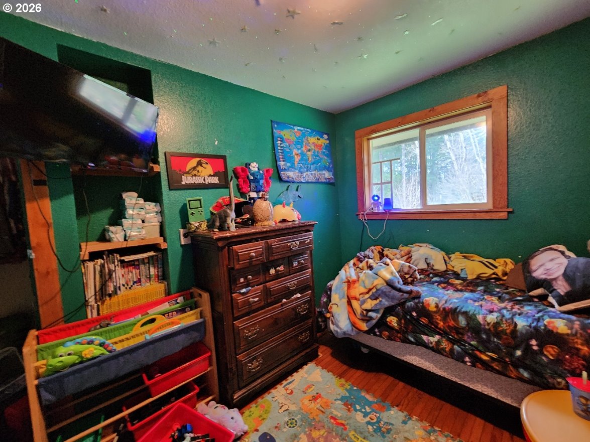 45366 Highway 101 Sixes, OR 97476 - Photo 14 of 34 a room with toys and flat screen tv