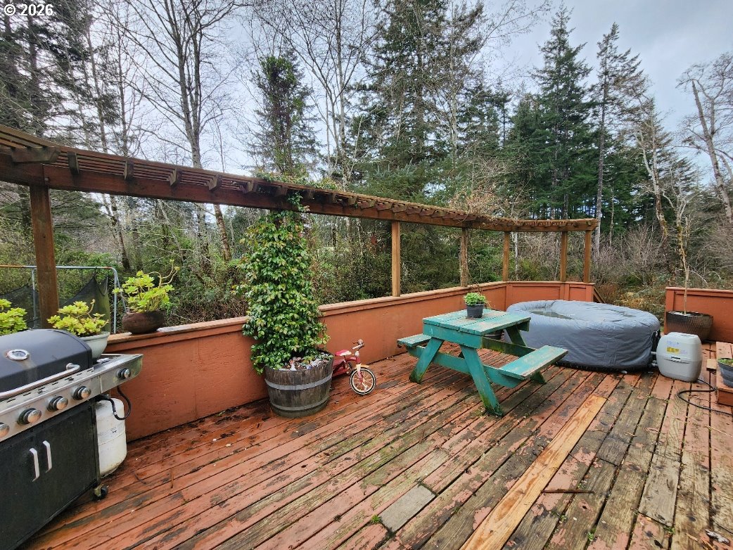 45366 Highway 101 Sixes, OR 97476 - Photo 22 of 34 a backyard of a house with wooden floor and outdoor seating