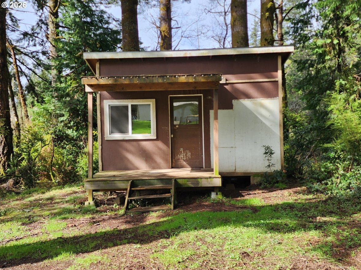 45366 Highway 101 Sixes, OR 97476 - Photo 24 of 34 a view of house with backyard and sitting area