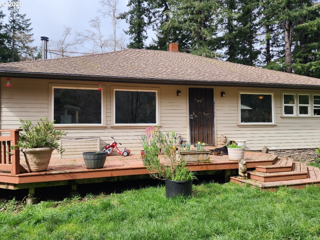 45366 Highway 101 Sixes, OR 97476 - Photo 3 of 34 a front view of a house with garden