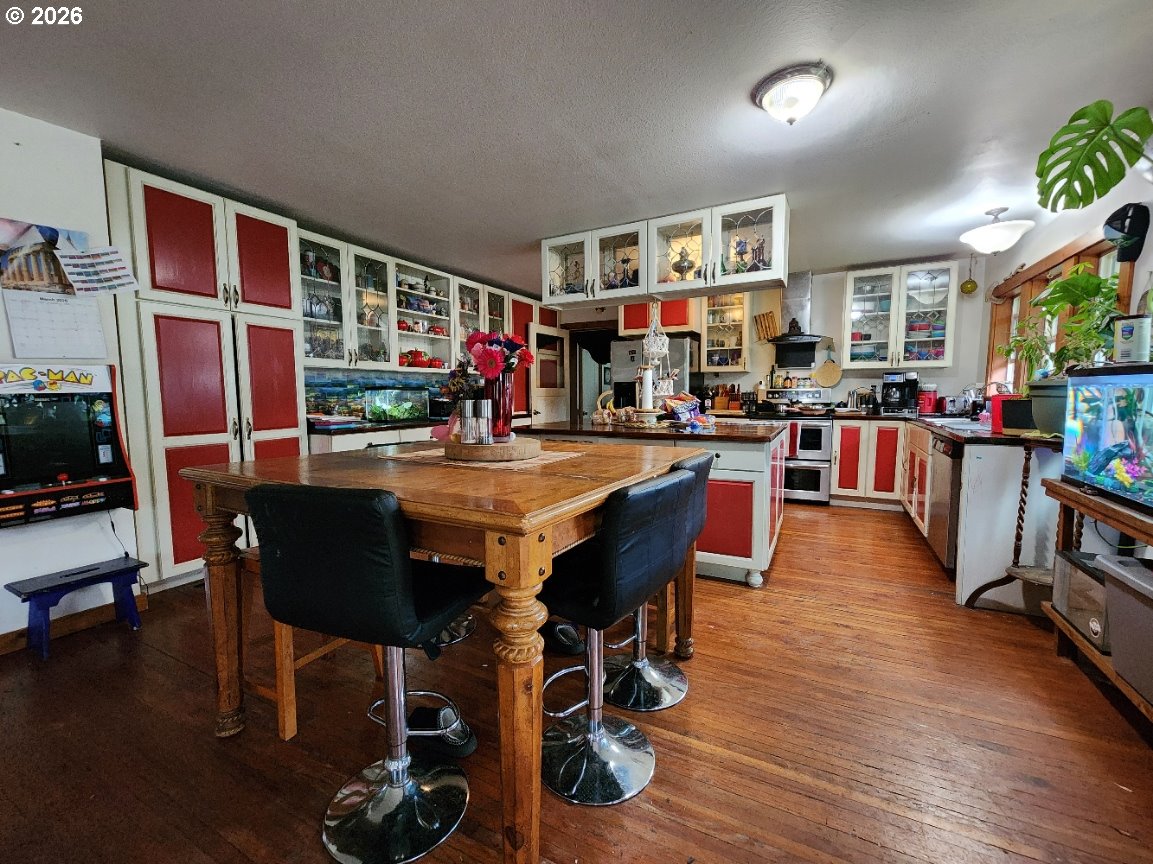 45366 Highway 101 Sixes, OR 97476 - Photo 4 of 34 a view of a dining room with furniture window and wooden floor