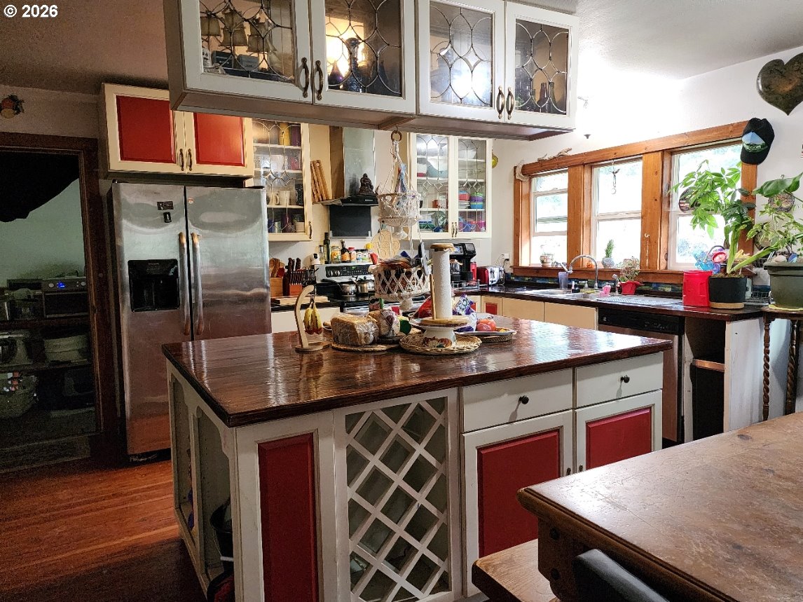 45366 Highway 101 Sixes, OR 97476 - Photo 5 of 34 a kitchen with stainless steel appliances granite countertop a sink stove and refrigerator