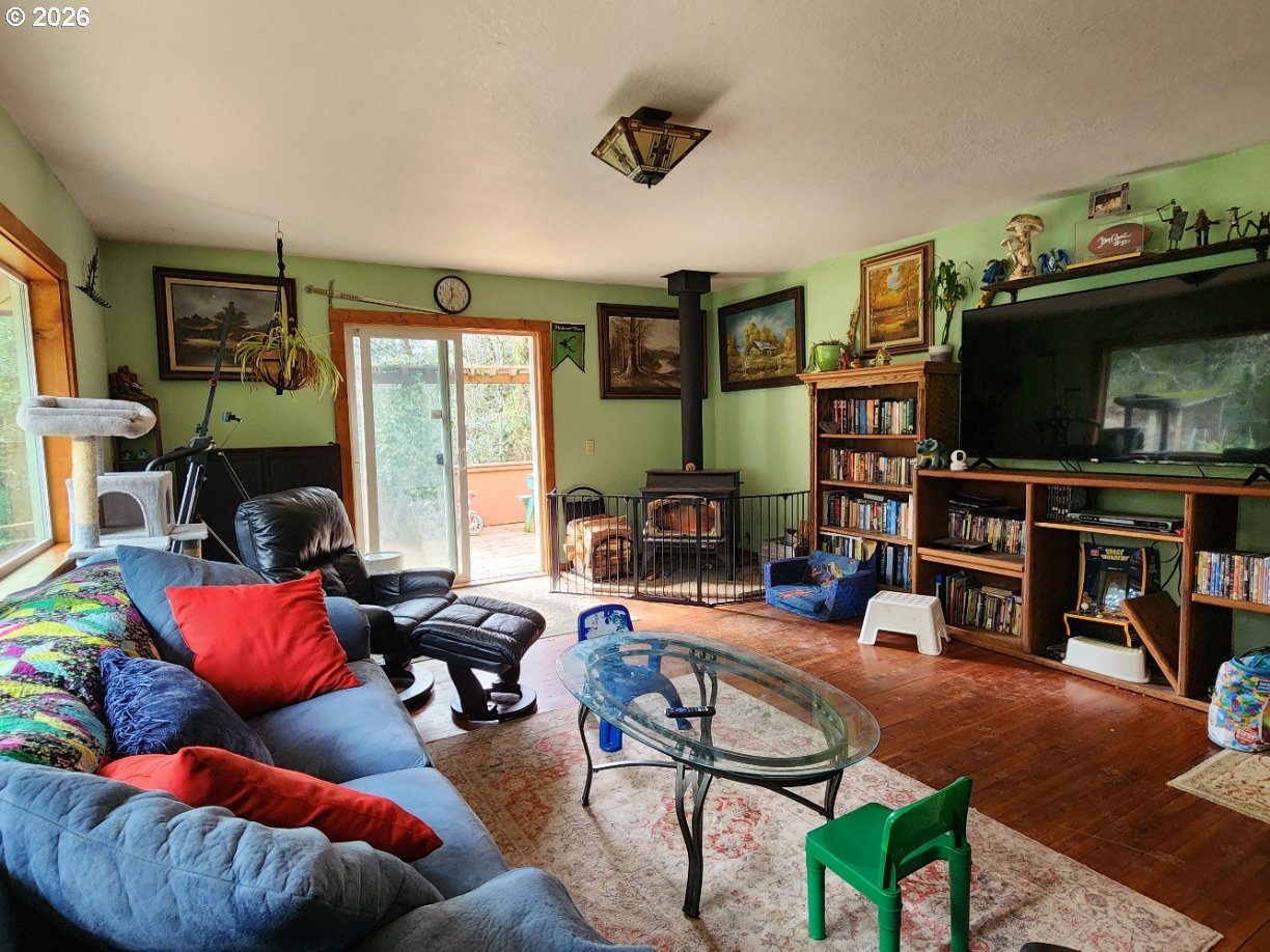45366 Highway 101 Sixes, OR 97476 - Photo 6 of 34 a living room with furniture and a flat screen tv