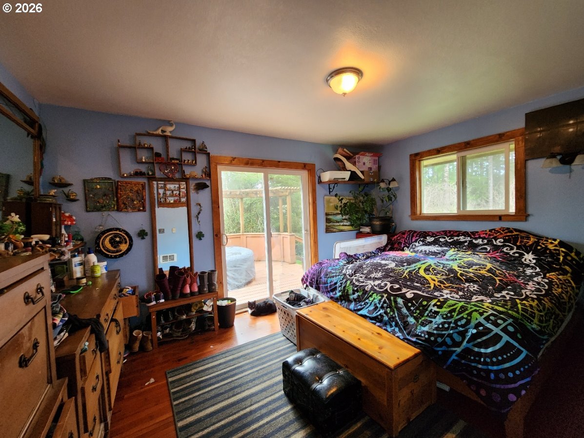 45366 Highway 101 Sixes, OR 97476 - Photo 8 of 34 a bed room with furniture and a window