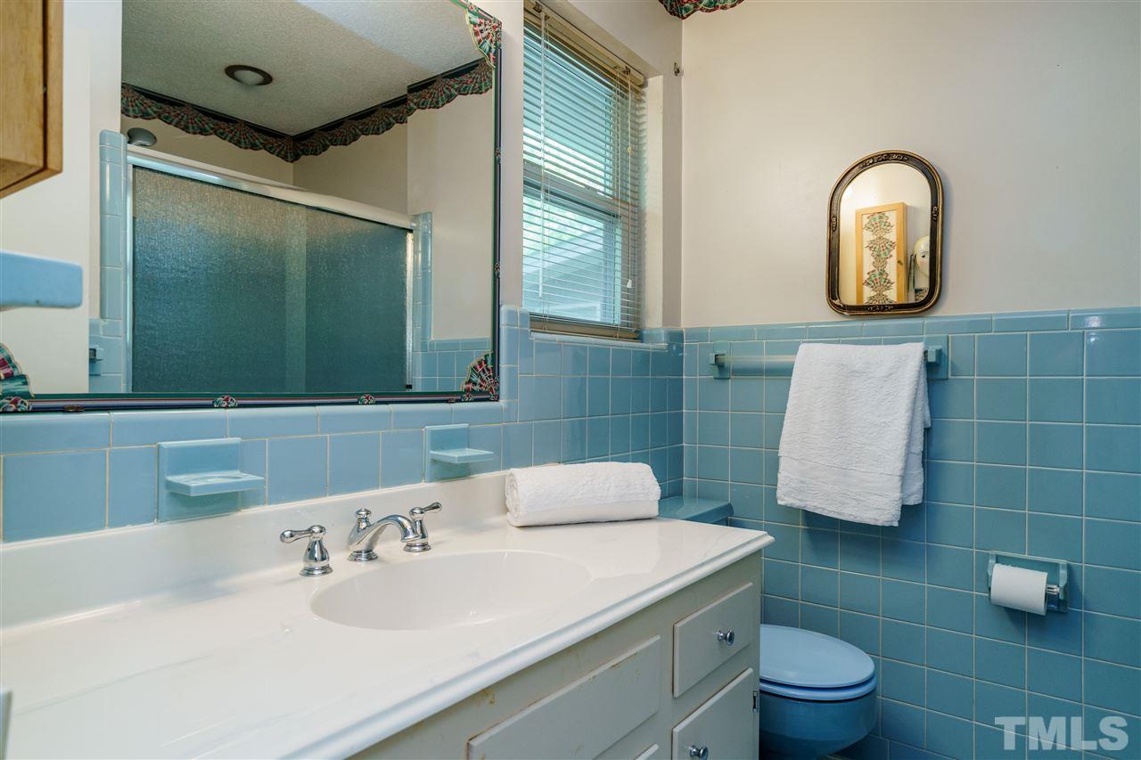 6512 King Lawrence Road Raleigh, NC 27607 - Photo 22 of 30 a bathroom with a sink toilet and a mirror