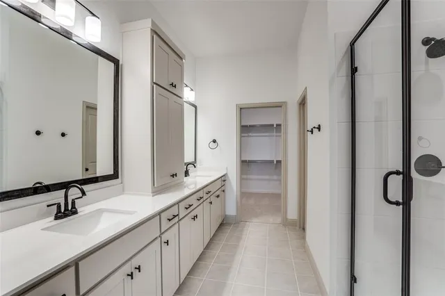 a bathroom with double vanity sinks and a mirror