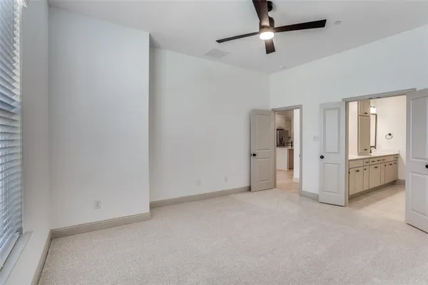 a view of empty room with cabinet and mirrors
