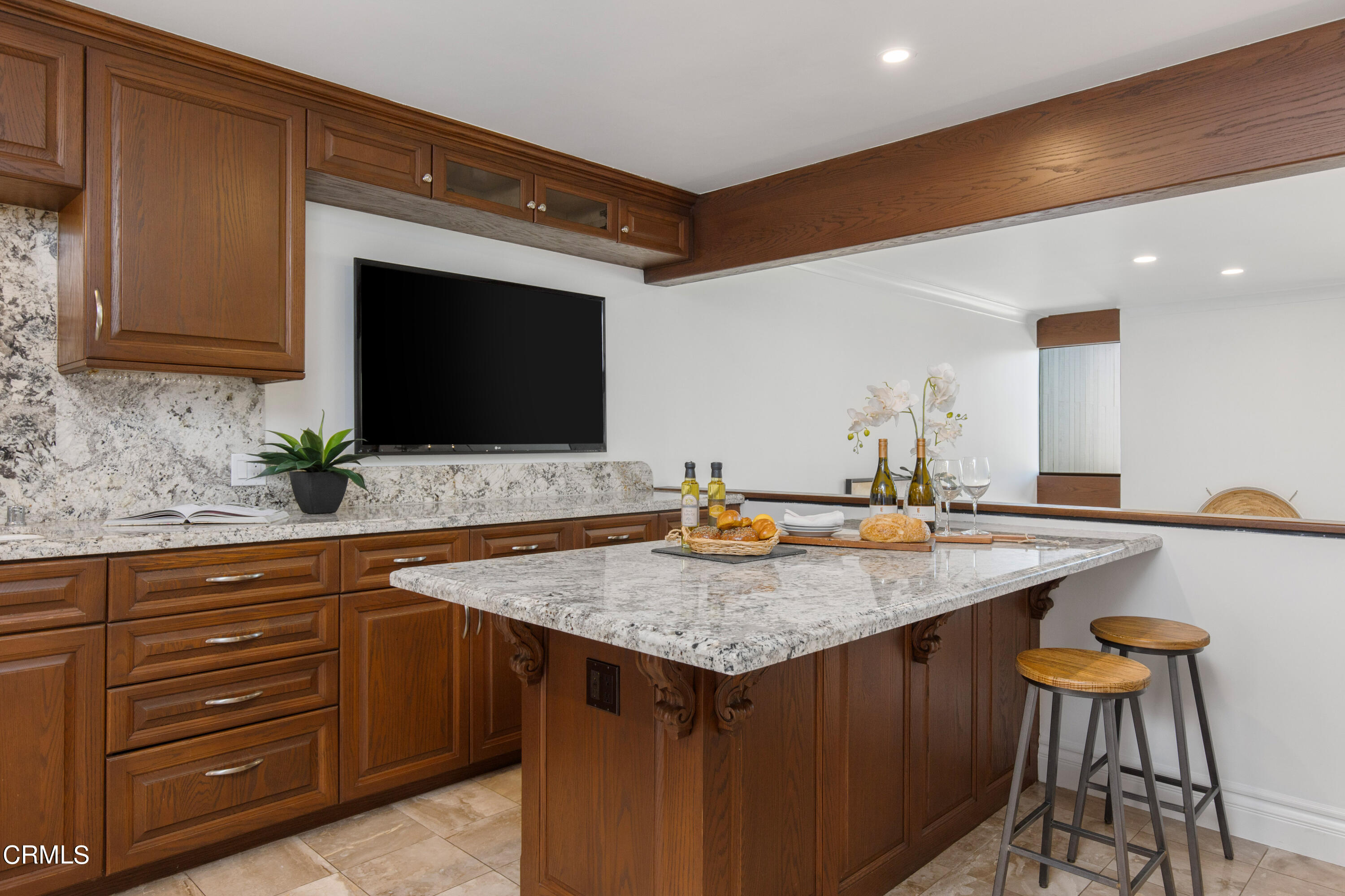 1 South Orange Grove Boulevard, Unit 12 Pasadena, CA 91105 - Photo 11 of 27 a kitchen with a stove a sink and a microwave