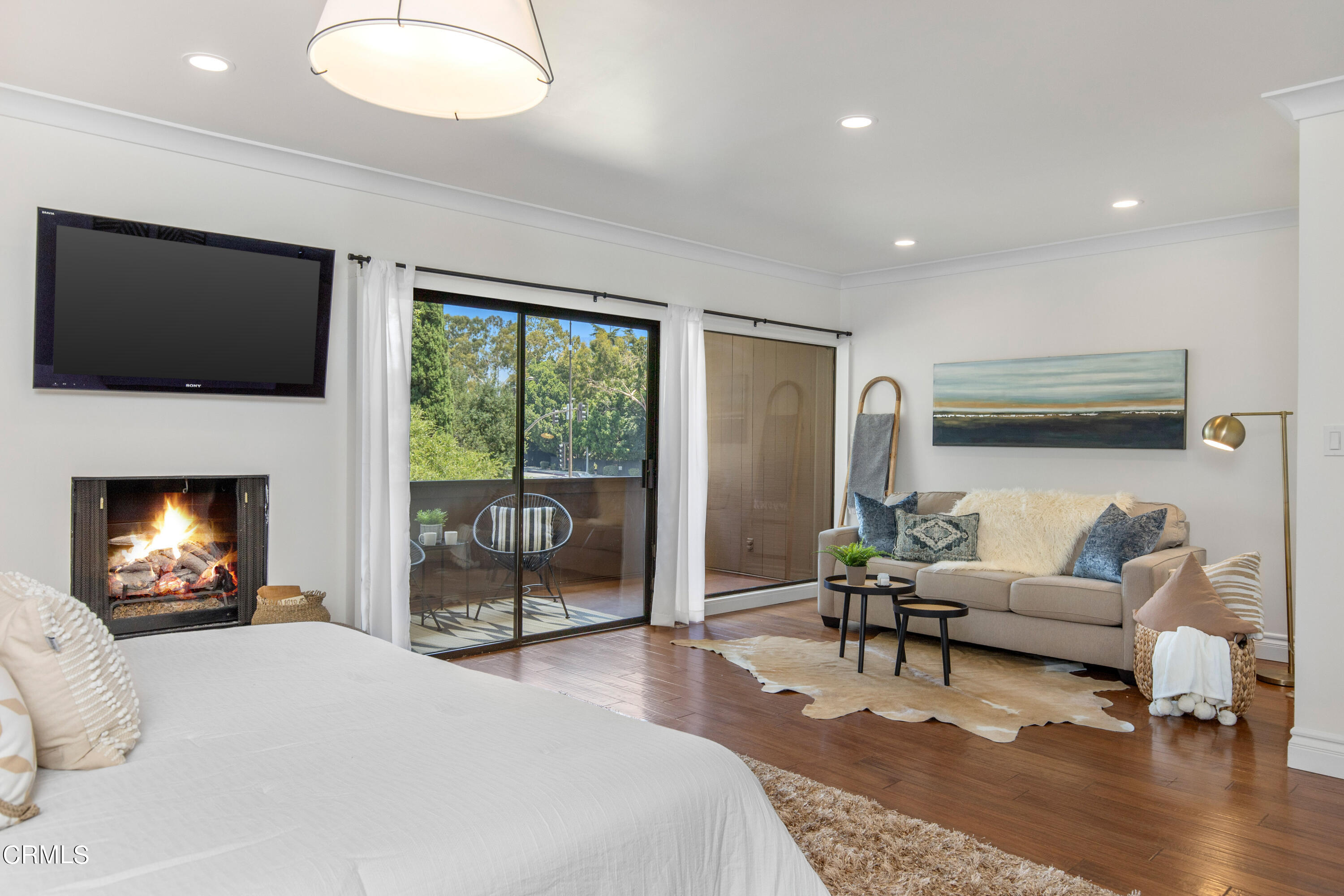 1 South Orange Grove Boulevard, Unit 12 Pasadena, CA 91105 - Photo 15 of 27 a bedroom with a bed and glass door