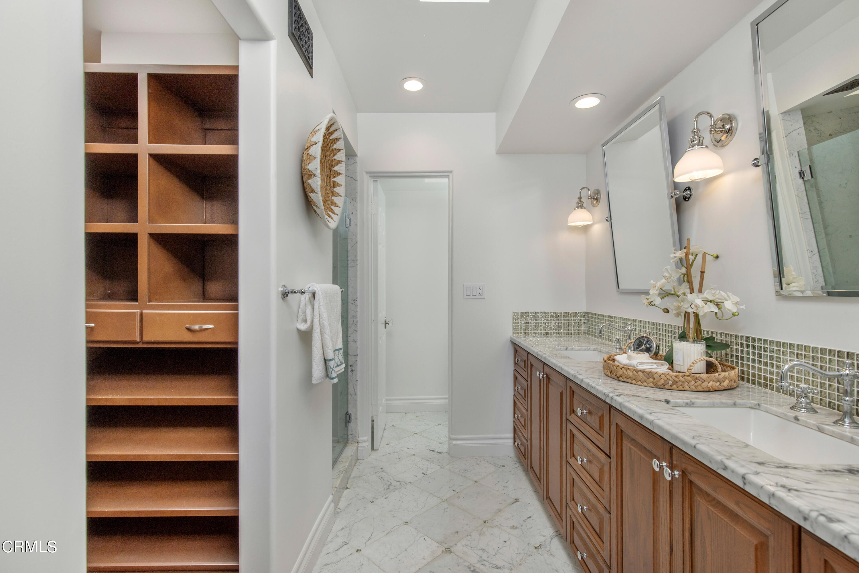 1 South Orange Grove Boulevard, Unit 12 Pasadena, CA 91105 - Photo 16 of 27 a bathroom with a granite countertop double vanity sink and mirror