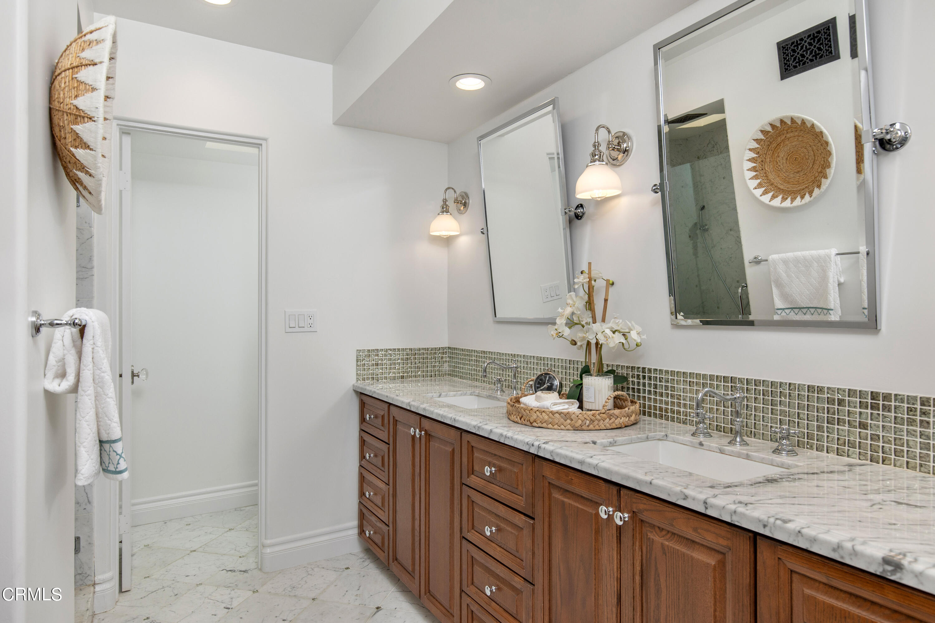 1 South Orange Grove Boulevard, Unit 12 Pasadena, CA 91105 - Photo 17 of 27 a bathroom with a granite countertop sink and a mirror
