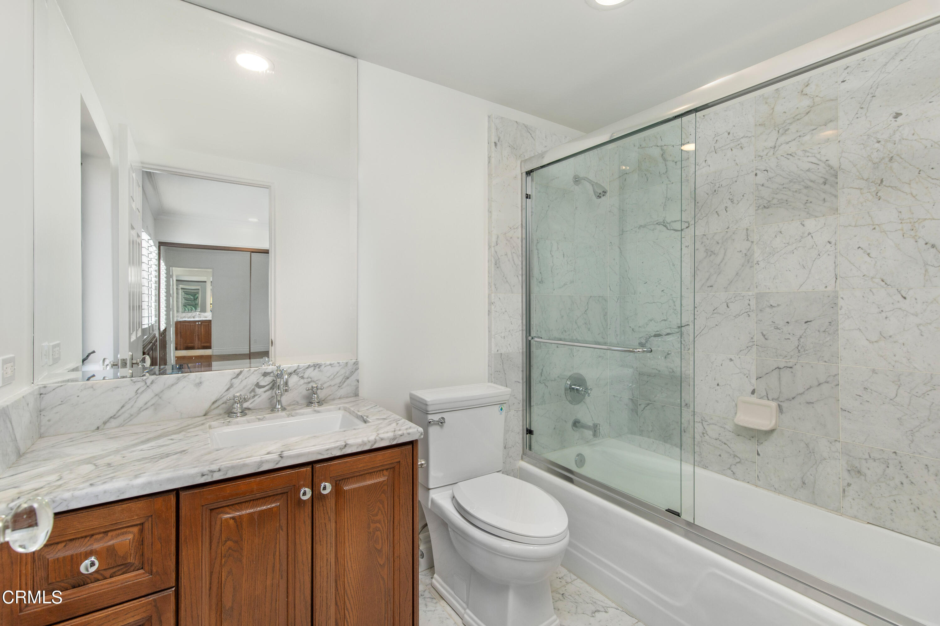 1 South Orange Grove Boulevard, Unit 12 Pasadena, CA 91105 - Photo 22 of 27 a bathroom with a granite countertop sink toilet and shower