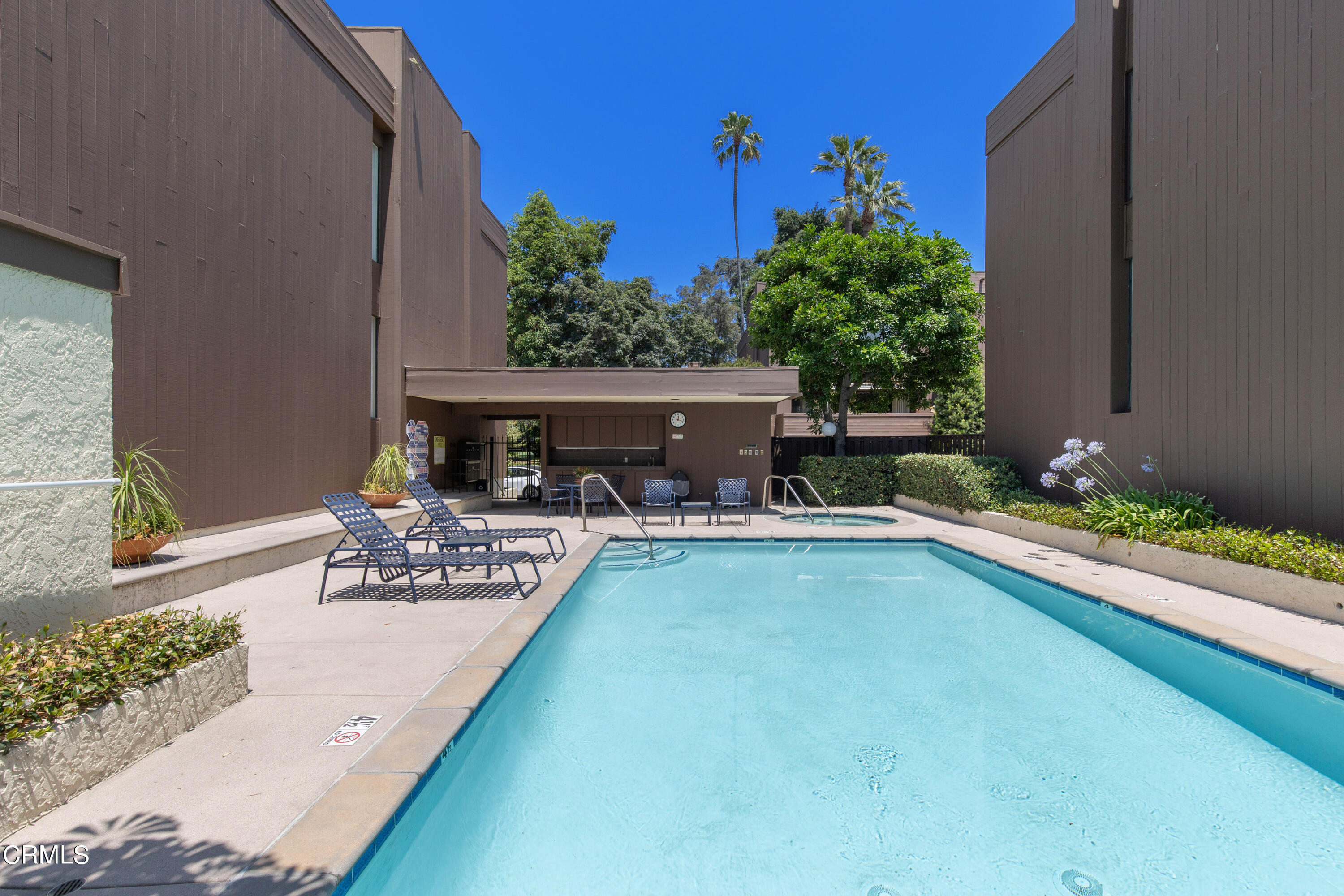 1 South Orange Grove Boulevard, Unit 12 Pasadena, CA 91105 - Photo 26 of 27 a view of a house with swimming pool and sitting area