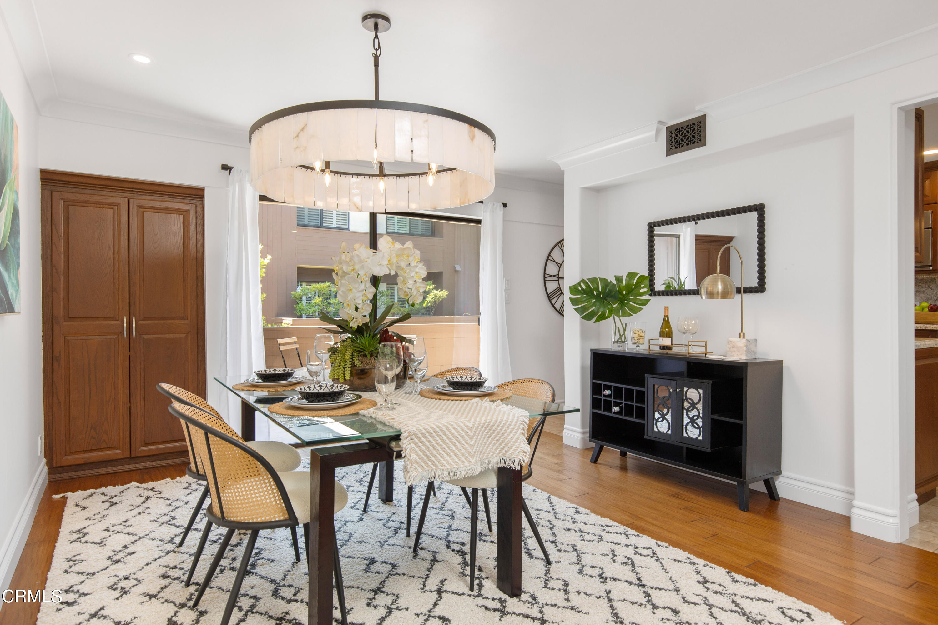1 South Orange Grove Boulevard, Unit 12 Pasadena, CA 91105 - Photo 7 of 27 a dining room with furniture a fireplace and wooden floor