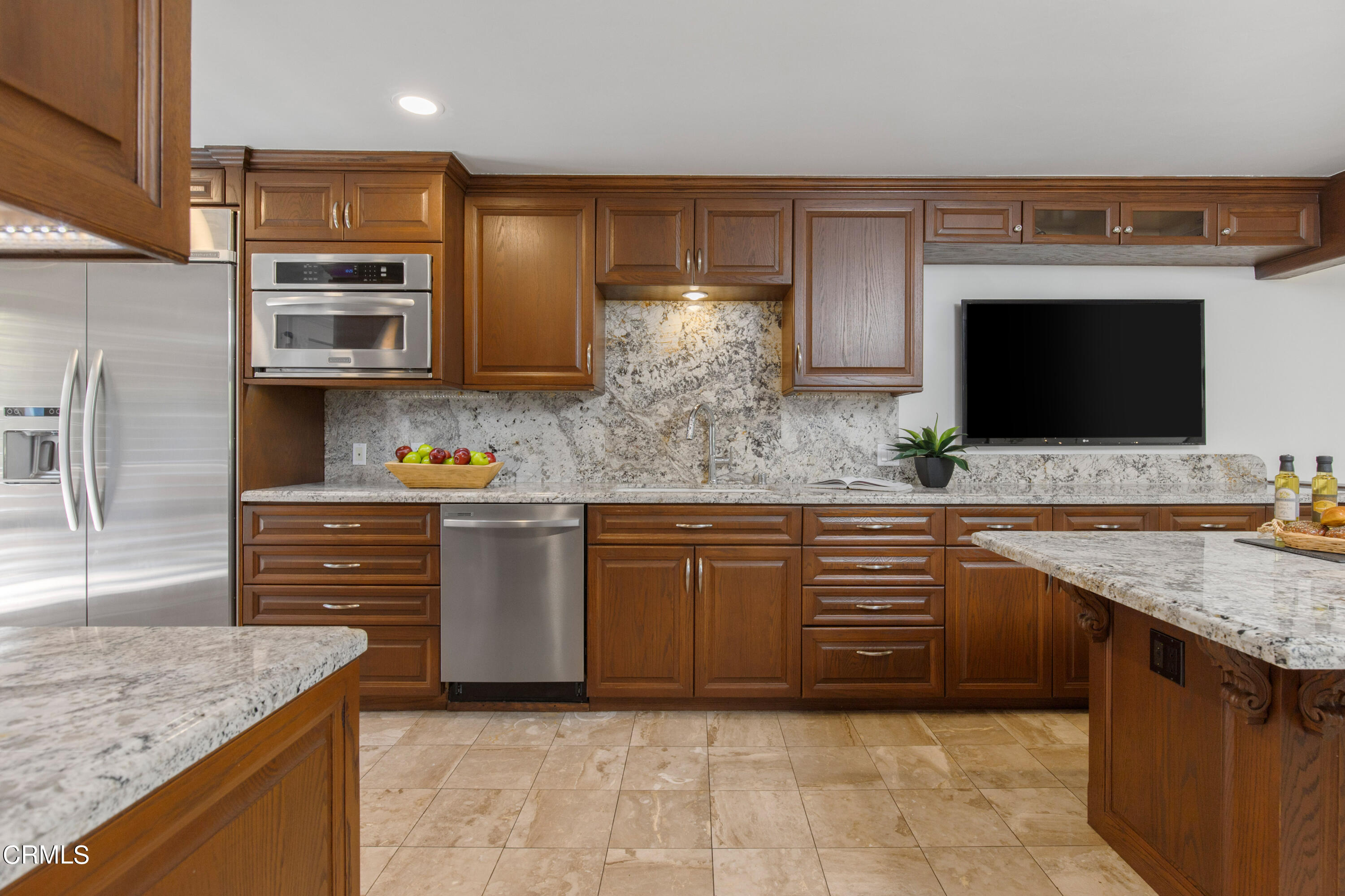1 South Orange Grove Boulevard, Unit 12 Pasadena, CA 91105 - Photo 9 of 27 a kitchen with stainless steel appliances granite countertop a sink and stove