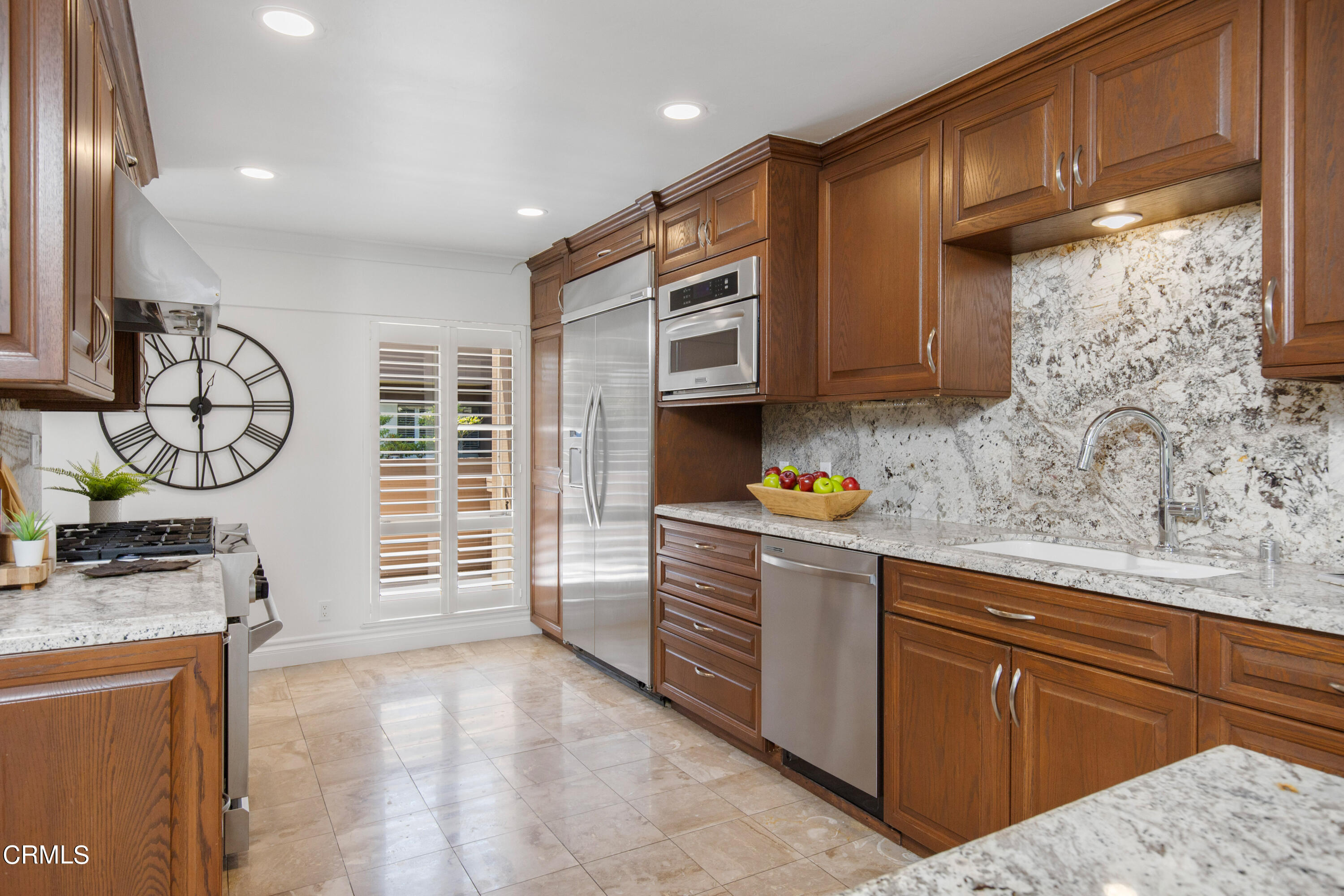 1 South Orange Grove Boulevard, Unit 12 Pasadena, CA 91105 - Photo 10 of 27 a kitchen with stainless steel appliances granite countertop a stove a sink and a microwave