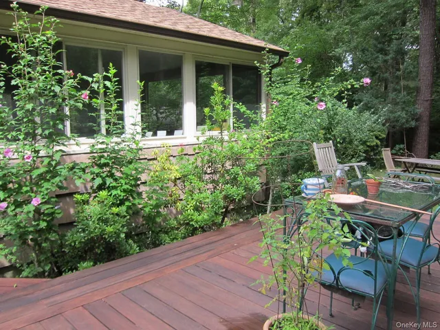 a view of an house with backyard and sitting area