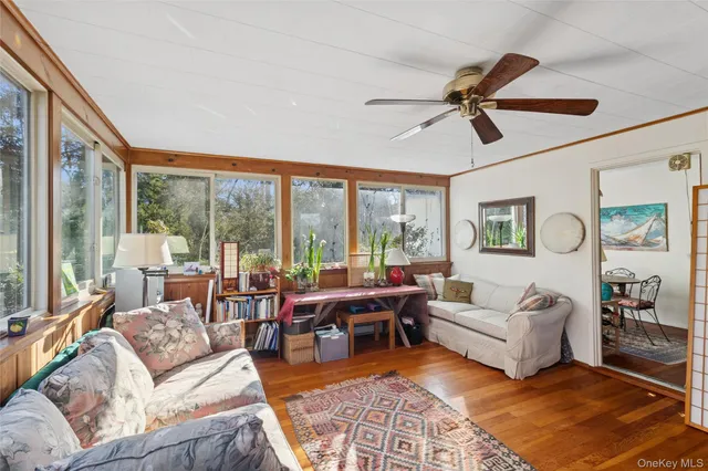 a living room with furniture large windows and a rug