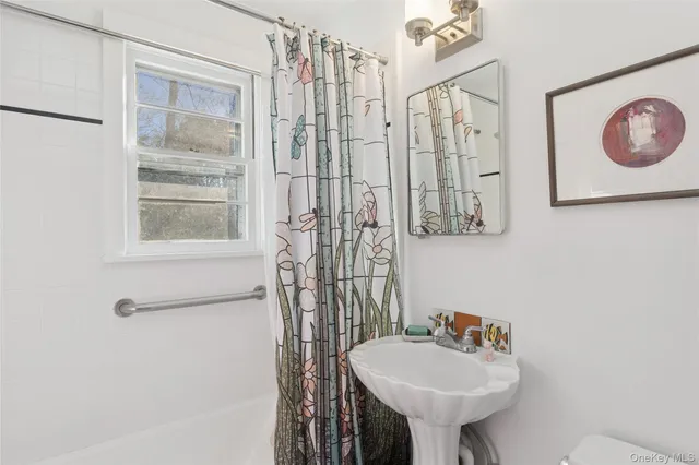 a bathroom with a sink a mirror and a shower