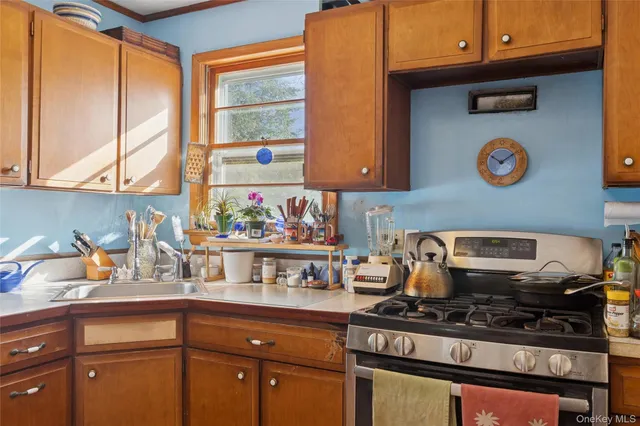 a kitchen with stainless steel appliances granite countertop a stove and a sink